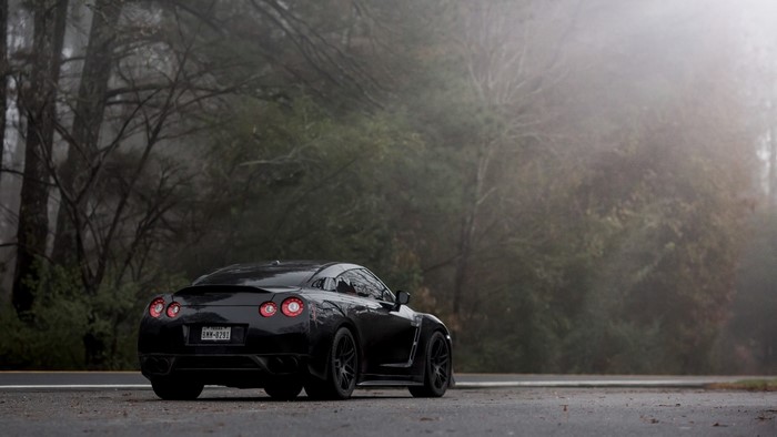 Black Nissan GT-R on a foggy road
