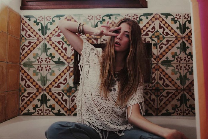 Woman with long hair making peace sign