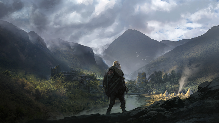 Man overlooking a valley with a village and mountains