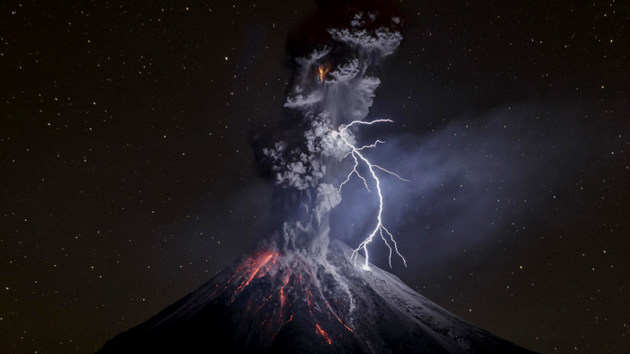 Volcanic eruption with lightning at night