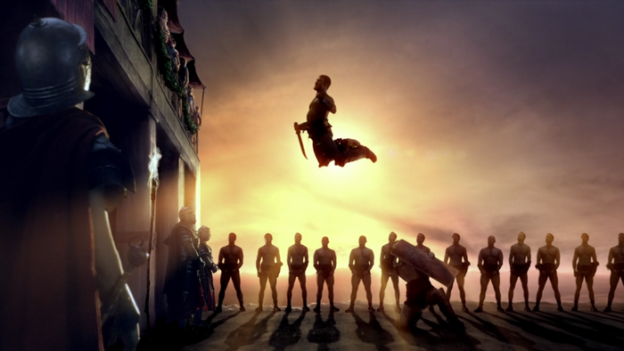 Spartacus in mid-air with gladiators and spectators