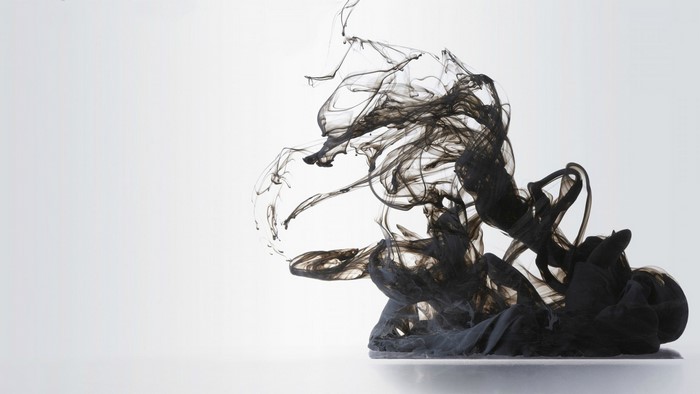 Black ink dissolving in water abstract art
