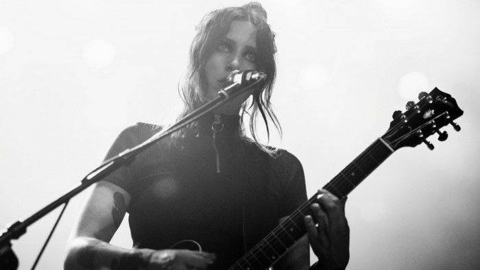 Chelsea Wolfe performing with a guitar