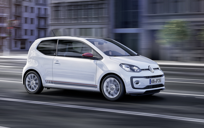 White Volkswagen Up driving on a city street