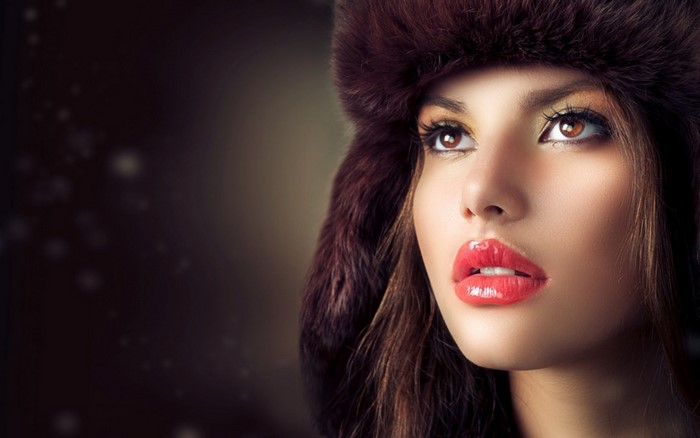 Woman wearing a fur hat with red lips