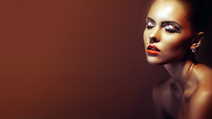 Woman with artistic makeup and red lips
