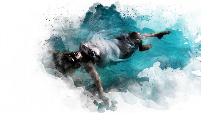 Woman in white dress floating in water