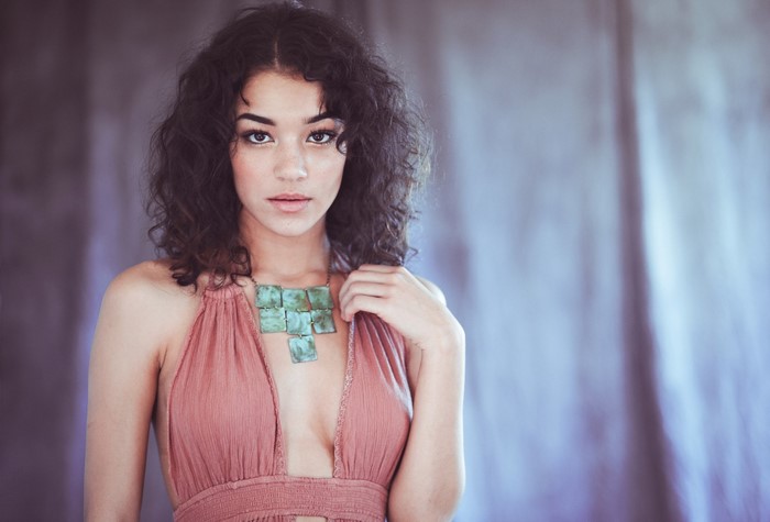 Woman with curly hair and necklace