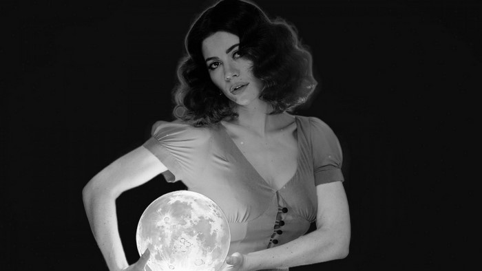 Woman holding a glowing moon