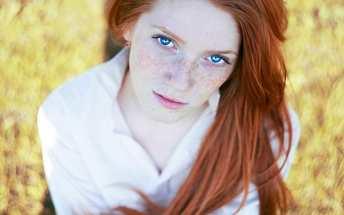 Redheaded Woman with Freckles and Blue Eyes
