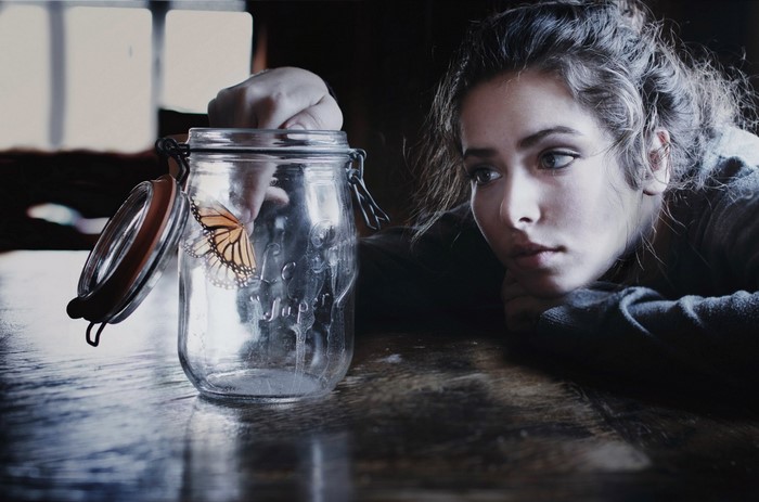 Woman with butterfly in a jar
