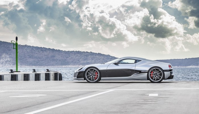 Silver Rimac Concept One supercar on a pier
