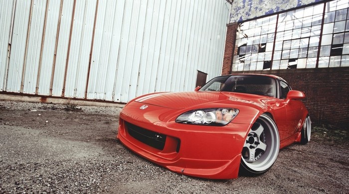 Red Honda S2000 sports car with custom wheels