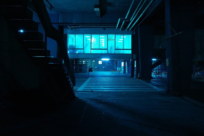 Blue lit urban underpass at night