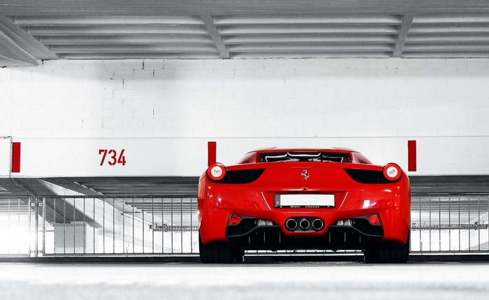 Red Ferrari 458 Italia parked in a garage