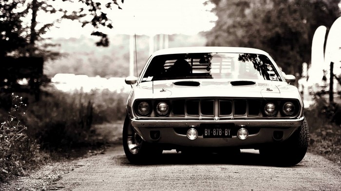 Monochrome Plymouth Hemi Cuda on a dirt road