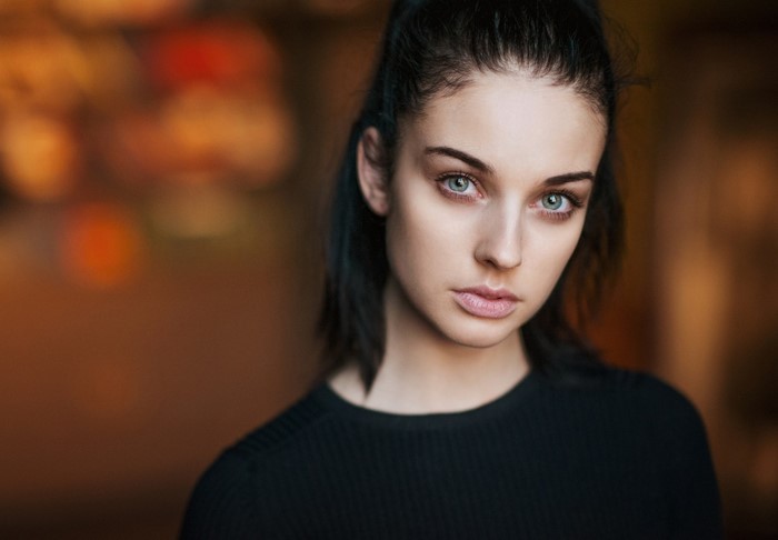 Portrait of a young woman with blue eyes and black hair