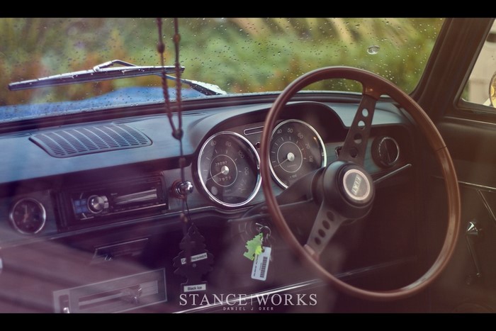 Vintage FIAT car interior with wooden steering wheel