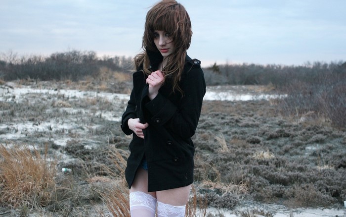 Susan Coffey in black coat and white stockings