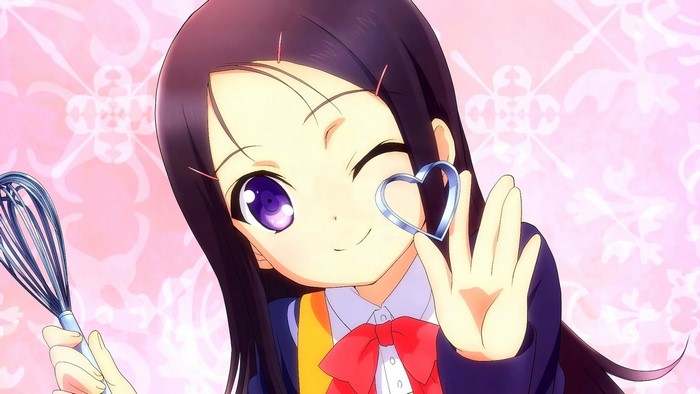 Otosaka Ayumi from Charlotte holding a heart cookie cutter