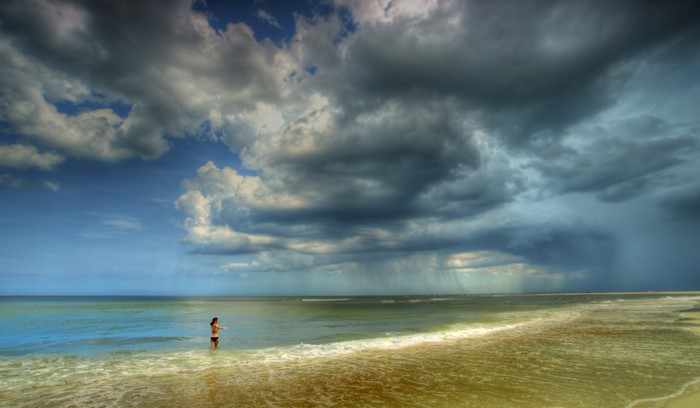 Woman in the sea during a storm