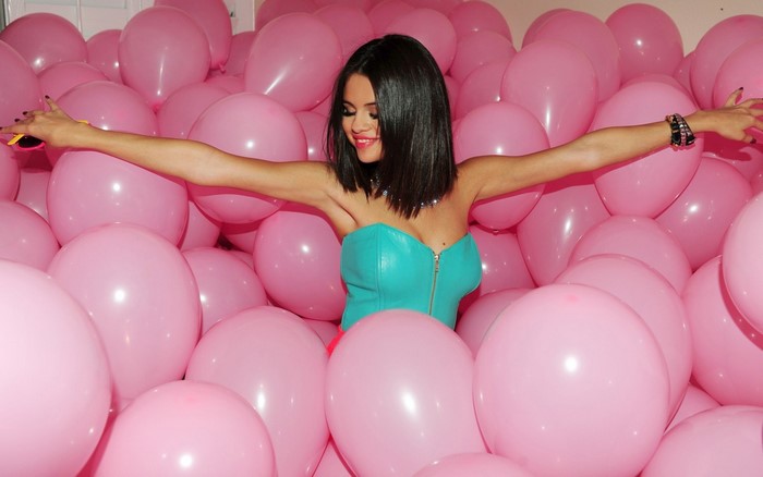Selena Gomez surrounded by pink balloons