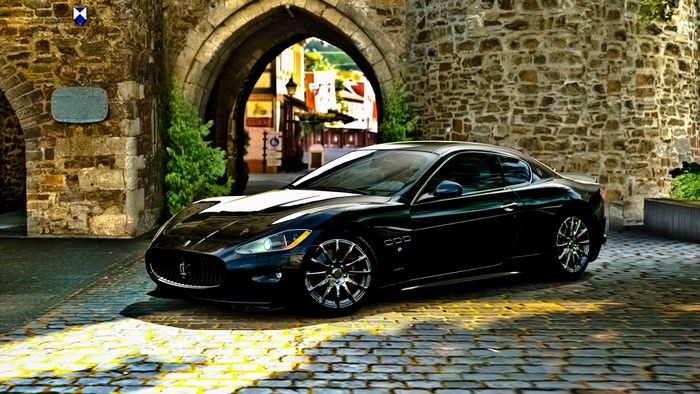 Black Maserati GranTurismo parked in stone archway