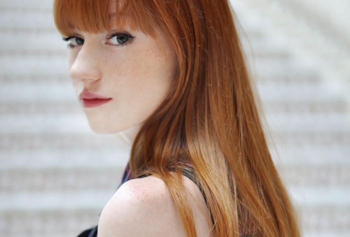 Portrait of Young Redhead Woman with Bangs