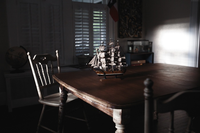 Model sailing ship on a table in a room