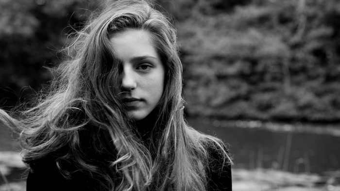 Monochrome portrait of a young woman with long hair
