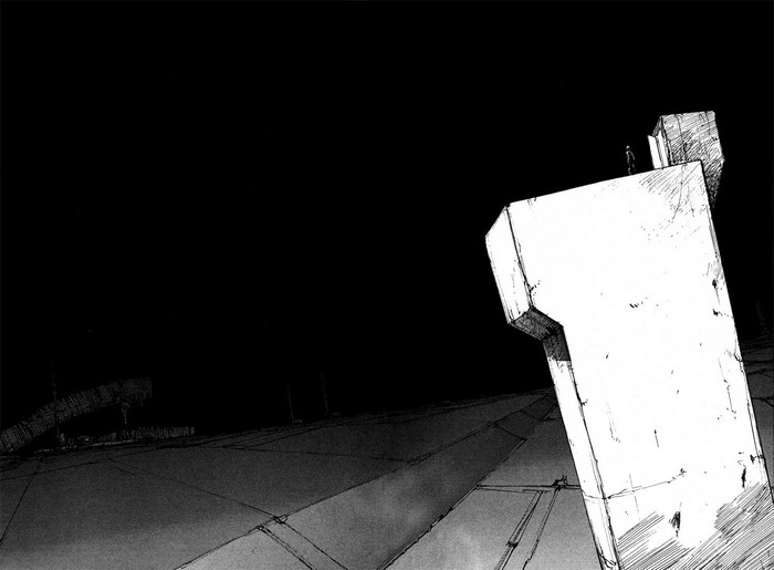 Man standing on a large white structure in darkness