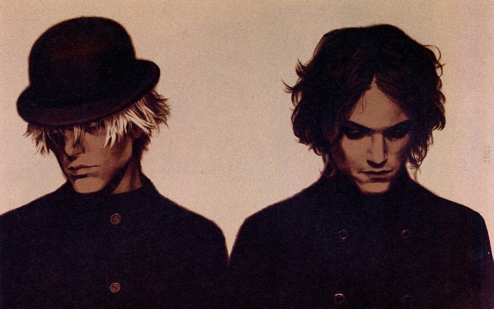 Two men in dark coats and hats