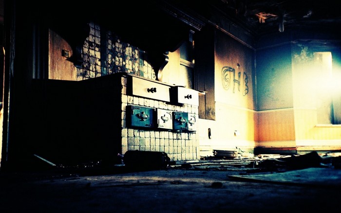 Abandoned kitchen with graffiti and bright light