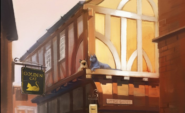 Two cats on a building facade with a "Golden Cat" sign