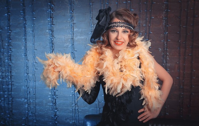 Woman in a flapper costume with feather boa