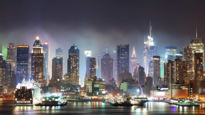 New York City skyline at night with cruise ships