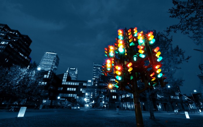 Colorful traffic lights tree in a city at night