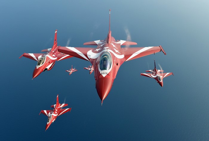 Formation of red and white fighter jets flying in formation