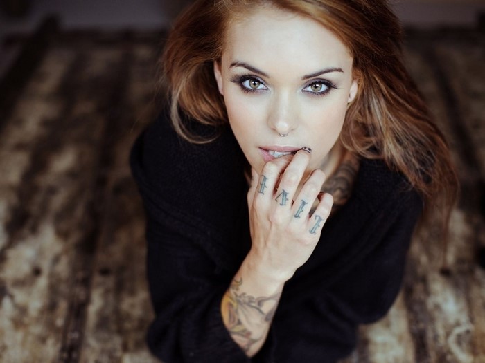 Woman with tattoos looking at viewer