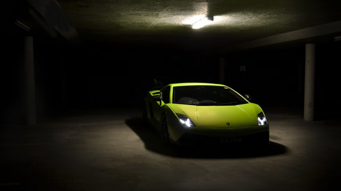 Lime green Lamborghini Gallardo in a dark parking garage