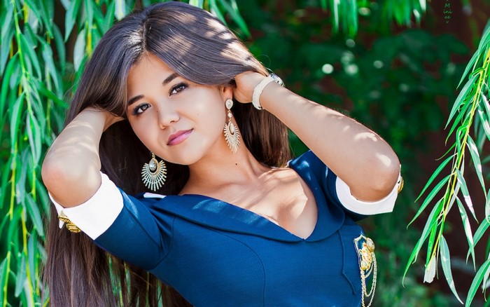 Woman with long dark hair and large earrings