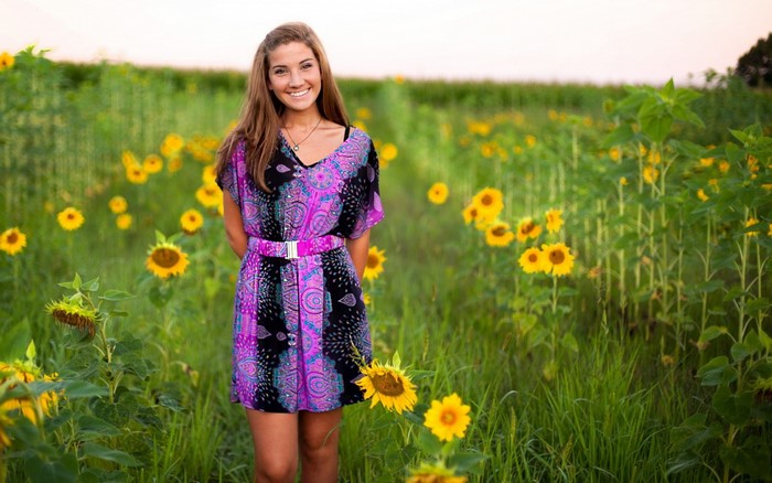 Woman in a patterned dress in a sunflower field