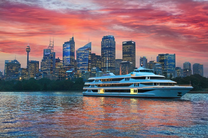 Sydney skyline with Captain Cook Cruises ship at sunset