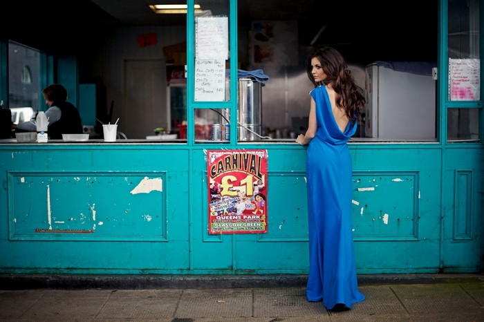 Woman in blue dress at a food stand