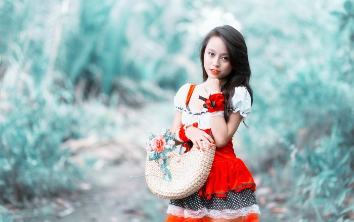 Asian woman in red dress holding a basket
