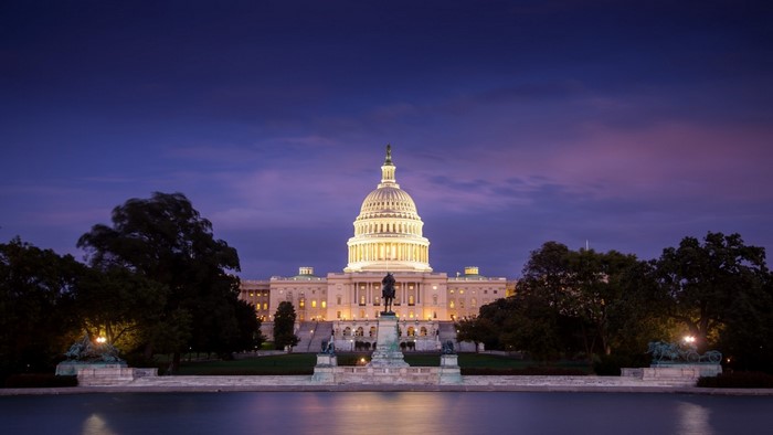 United States Capitol Building at dusk with reflection