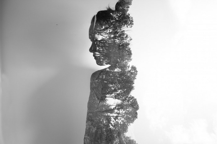 Double exposure of a woman and trees