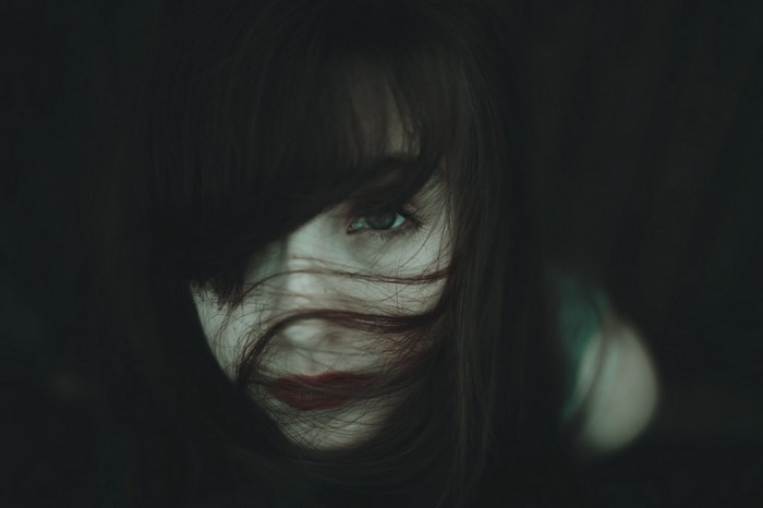Woman with hair in face and red lipstick