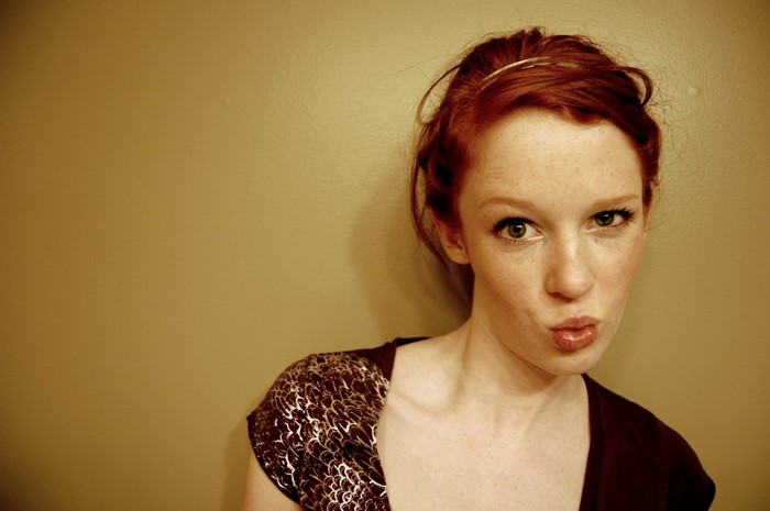 Redhead woman with freckles wearing a patterned top