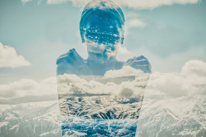 Double exposure of a woman and snowy mountains